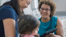 Healthcare worker talking to patient and child