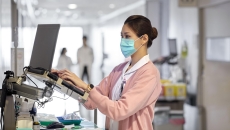 Medical professional using a laptop.