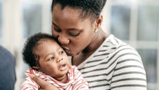 Parent kissing baby
