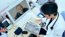 A doctor discussing a patient's X-ray via video call