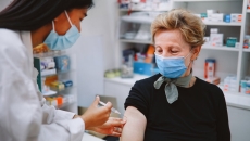 A pharmacist administering a vaccine shot