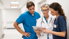 Hospital staff review info on a tablet