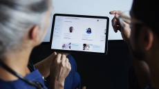 Healthcare workers looking at scheduling app on a tablet