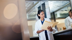 A doctor looking at a patient paper record