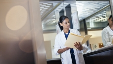 A doctor looking at a patient's paper records