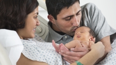 Parents holding newborn baby