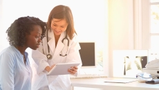 Doctor showing patient tablet