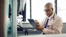 A doctor using a digital tablet