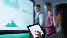 Researchers looking at graphs and trend lines
