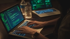 People in a darkened room at a computer