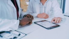 Healthcare workers looking at a tablet