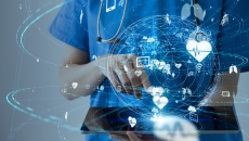 Healthcare worker using tablet with healthcare icons swirling above