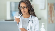 Doctor gesturing to laptop screen