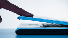 Hand closing a laptop