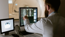 Person examines medical images on a screen