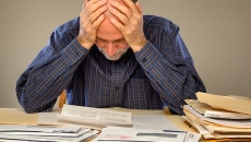 Distressed senior with paperwork