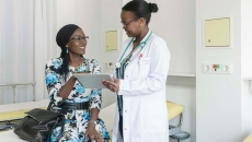 Doctor showing tablet to patient