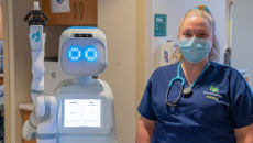 Person in PPE with robot