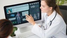 Doctor pointing to electronic medical record on a screen
