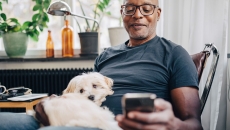 Person with dog using a smartphone