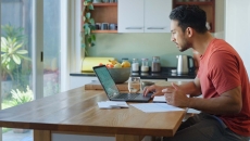 Person using a laptop in a kitchen