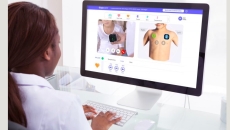 A doctor virtually examining a patient via Tyto Care desktop system.