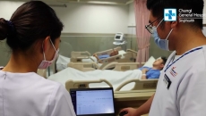 Nurses remotely checking the vital signs of a mock patient through a dashboard