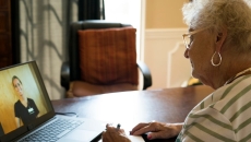 Person speaking to healthcare worker on laptop