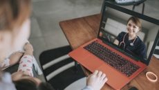 Patient and child talking to doctor on laptop
