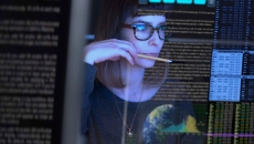 Worker looking at computer code display