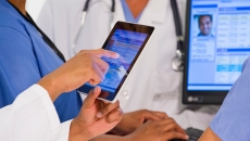 A doctor points to an address in an EHR