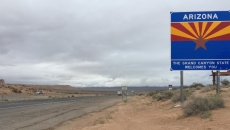 A highway sign with the words "Welcome to Arizona"