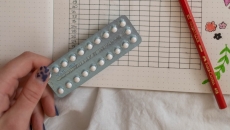 A hand holding birth control