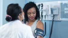 A doctor takes a patient's blood pressure