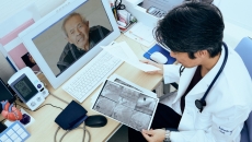 A doctor speaking with a patient via videoconference