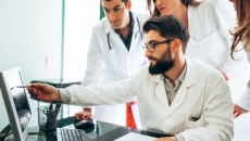 Healthcare workers looking at computer monitor