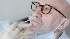 A person getting tested for COVID-19 with a nose swab