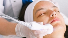 A dermatologist uses a device on a patient