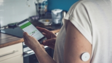 Patient checking glucose levels on a phone app