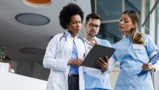 Clinicians look at a tablet