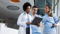 Healthcare workers looking at clipboard