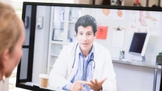 A patient speaking with their doctor via telehealth