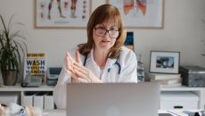 A doctor looking at a computer screen