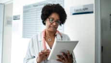 A doctor looking at a tablet
