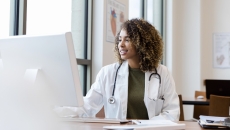 A doctor on a computer looking at a patient's electronic health record