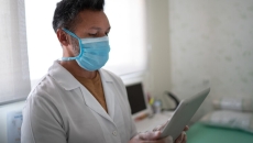 A doctor speaking with a patient via tablet