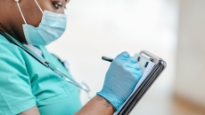 A doctor manually taking notes