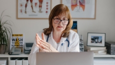 A doctor sitting in front of a computer