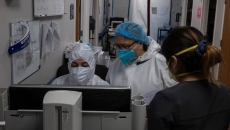 Doctors gather at a computer