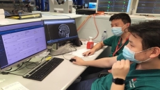 Healthcare staff looking at a computer.